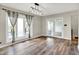 Bright dining area boasts wood floors, natural light from large windows, and modern light fixture at 676 La Placita St, Greenwood, IN 46143