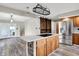 Charming kitchen with wood cabinets, granite countertops, and a center island with cooktop at 676 La Placita St, Greenwood, IN 46143