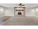 Spacious living room with a decorative brick fireplace and new carpet flooring at 676 La Placita St, Greenwood, IN 46143