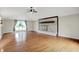Large open living room with a brick fireplace, hardwood floors, and neutral paint at 676 La Placita St, Greenwood, IN 46143