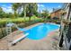 Bright blue in-ground pool with diving board and slide at 676 La Placita St, Greenwood, IN 46143