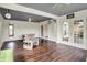 Cozy sunroom with wood flooring, cement furniture, and white trim is the perfect indoor getaway at 676 La Placita St, Greenwood, IN 46143