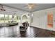 Inviting sunroom features wood floors, unique concrete furniture, and large windows with outdoor views at 676 La Placita St, Greenwood, IN 46143