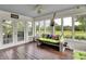Inviting sunroom with views of the outdoors features unique furniture and ceiling fan lighting at 676 La Placita St, Greenwood, IN 46143