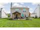 Spacious backyard features a covered patio with an outdoor kitchen and mature landscaping at 6842 Viola Ct, Indianapolis, IN 46237