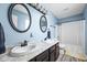 Light-filled bathroom features dual sinks, framed mirrors, and a shower/tub combo at 6842 Viola Ct, Indianapolis, IN 46237
