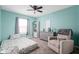 Serene bedroom offers a cozy armchair, a dresser, and a twin-sized bed at 6842 Viola Ct, Indianapolis, IN 46237