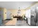 Bright dining area adjacent to the kitchen, featuring modern appliances and a cozy dining set for Gathering meals at 6842 Viola Ct, Indianapolis, IN 46237