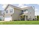 Well-maintained two-story home featuring a landscaped front yard and attached two car garage at 6842 Viola Ct, Indianapolis, IN 46237