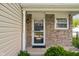 Close-up view of the front door with brick accents and a 