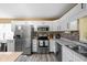 Modern kitchen with stainless steel appliances, white cabinets, and a stylish backsplash, creating a culinary haven at 6842 Viola Ct, Indianapolis, IN 46237