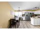 Bright eat-in kitchen features stainless steel appliances, white cabinetry, and wood-look laminate flooring at 6842 Viola Ct, Indianapolis, IN 46237