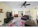 Bright and airy living room with a piano, comfortable seating, and a large TV, perfect for entertaining and relaxation at 6842 Viola Ct, Indianapolis, IN 46237