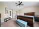 Comfortable main bedroom with a blue cushioned bench at the end of a wood bed frame at 6842 Viola Ct, Indianapolis, IN 46237