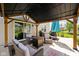 View of the covered patio with comfortable seating and outdoor cooking space at 6842 Viola Ct, Indianapolis, IN 46237