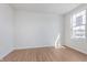 Bright bedroom featuring hardwood floors and a large window at 6871 Seabiscuit Rd, Whitestown, IN 46075