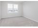 Bright bedroom with neutral carpet and large window, providing a comfortable living space at 6871 Seabiscuit Rd, Whitestown, IN 46075