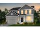 Charming two-story home boasts gray siding, stone accents, and a two-car garage at 6871 Seabiscuit Rd, Whitestown, IN 46075