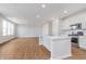 Spacious kitchen area boasts an island, stainless steel appliances, and wood floors at 6871 Seabiscuit Rd, Whitestown, IN 46075