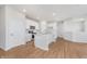 Open-concept kitchen features an island, white cabinets, and stainless steel appliances at 6871 Seabiscuit Rd, Whitestown, IN 46075
