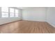 Bright living room with hardwood floors, light paint, and large windows at 6871 Seabiscuit Rd, Whitestown, IN 46075