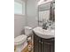Neutral bathroom with white fixtures, wood-look floors, and a dark vanity at 70 Casco Dr, Avon, IN 46123