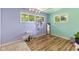 Pastel-colored bedroom featuring three windows, wood-look floors, and a cat tree at 70 Casco Dr, Avon, IN 46123