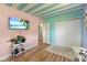 Bedroom with pink and turquoise walls, wood-look floors, and white closet doors at 70 Casco Dr, Avon, IN 46123