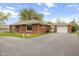View of exterior elevation and long driveway leading to detached garage on this brick home at 70 Casco Dr, Avon, IN 46123