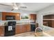 Kitchen features stainless steel appliances, wood cabinets, and plank floors at 70 Casco Dr, Avon, IN 46123