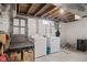 Functional laundry room features a washer and dryer and unfinished ceiling with exposed beams at 70 Casco Dr, Avon, IN 46123