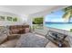 Comfortable living room featuring a gray rug, plush seating and beach scene on the television at 70 Casco Dr, Avon, IN 46123