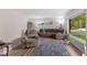 Cozy living room with plush seating, a large window and wood laminate floors at 70 Casco Dr, Avon, IN 46123