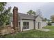 Charming home exterior with a brick chimney and spacious green backyard at 7053 Colita More Nw Ct, Indianapolis, IN 46254