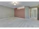 Spacious carpeted bedroom with gray and mauve accent wall, walk-in closet and ceiling light at 7053 Colita More Nw Ct, Indianapolis, IN 46254