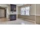 Bright dining area with wood laminate floors, modern light fixture, and view to the kitchen at 7053 Colita More Nw Ct, Indianapolis, IN 46254
