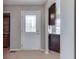 Entryway featuring an ornate glass door, wood laminate floors, and dark wood cabinets at 7053 Colita More Nw Ct, Indianapolis, IN 46254