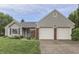 Charming one-story home features a two-car garage and well-manicured lawn at 7053 Colita More Nw Ct, Indianapolis, IN 46254