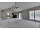 Spacious living room with vaulted ceiling, brick fireplace, and a large window for natural light at 7053 Colita More Nw Ct, Indianapolis, IN 46254