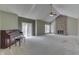Spacious living room with vaulted ceilings, brick fireplace, and sliding glass doors at 7053 Colita More Nw Ct, Indianapolis, IN 46254