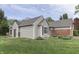 The back of this charming home is surrounded by a well-manicured lawn and mature trees at 7053 Colita More Nw Ct, Indianapolis, IN 46254