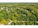 Scenic aerial shot of a residential area surrounded by dense, mature trees and winding roads at 7126 Nile Ridge Ct, Indianapolis, IN 46236