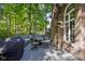 Backyard with a patio set, grill, well manicured yard and mature trees at 7126 Nile Ridge Ct, Indianapolis, IN 46236