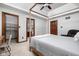 Bedroom showcasing a four-poster bed, ceiling fan, and view into the attached Primary bath at 7126 Nile Ridge Ct, Indianapolis, IN 46236
