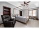 Spacious bedroom featuring a four-poster bed, ceiling fan, desk area, and built in shelving at 7126 Nile Ridge Ct, Indianapolis, IN 46236