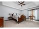 Well-lit bedroom featuring a tray ceiling, desk area, and large windows at 7126 Nile Ridge Ct, Indianapolis, IN 46236