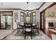 Inviting dining room features bay window, wood trim, chandelier, and access to sunroom and living room at 7126 Nile Ridge Ct, Indianapolis, IN 46236