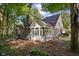 A home with a brick facade, lots of windows, mature trees and a deck at 7126 Nile Ridge Ct, Indianapolis, IN 46236