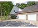 Exterior with three car garage, well maintained lawn, mature trees and brick at 7126 Nile Ridge Ct, Indianapolis, IN 46236