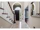 Bright foyer features tile floors, elegant staircase, and large window over the front door at 7126 Nile Ridge Ct, Indianapolis, IN 46236
